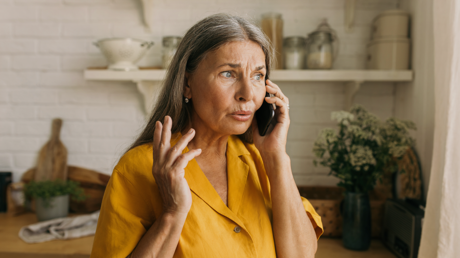 Woman speaking to a scammer on the phone.