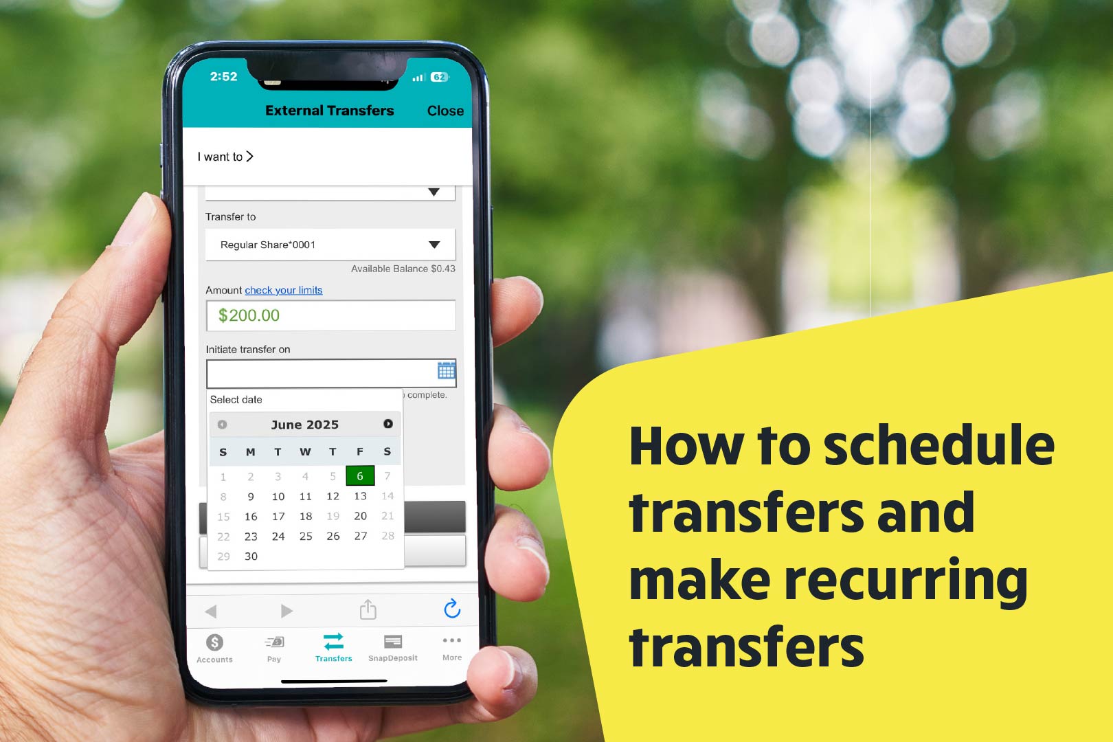 hand holding mobile phone against a blurred outdoor background