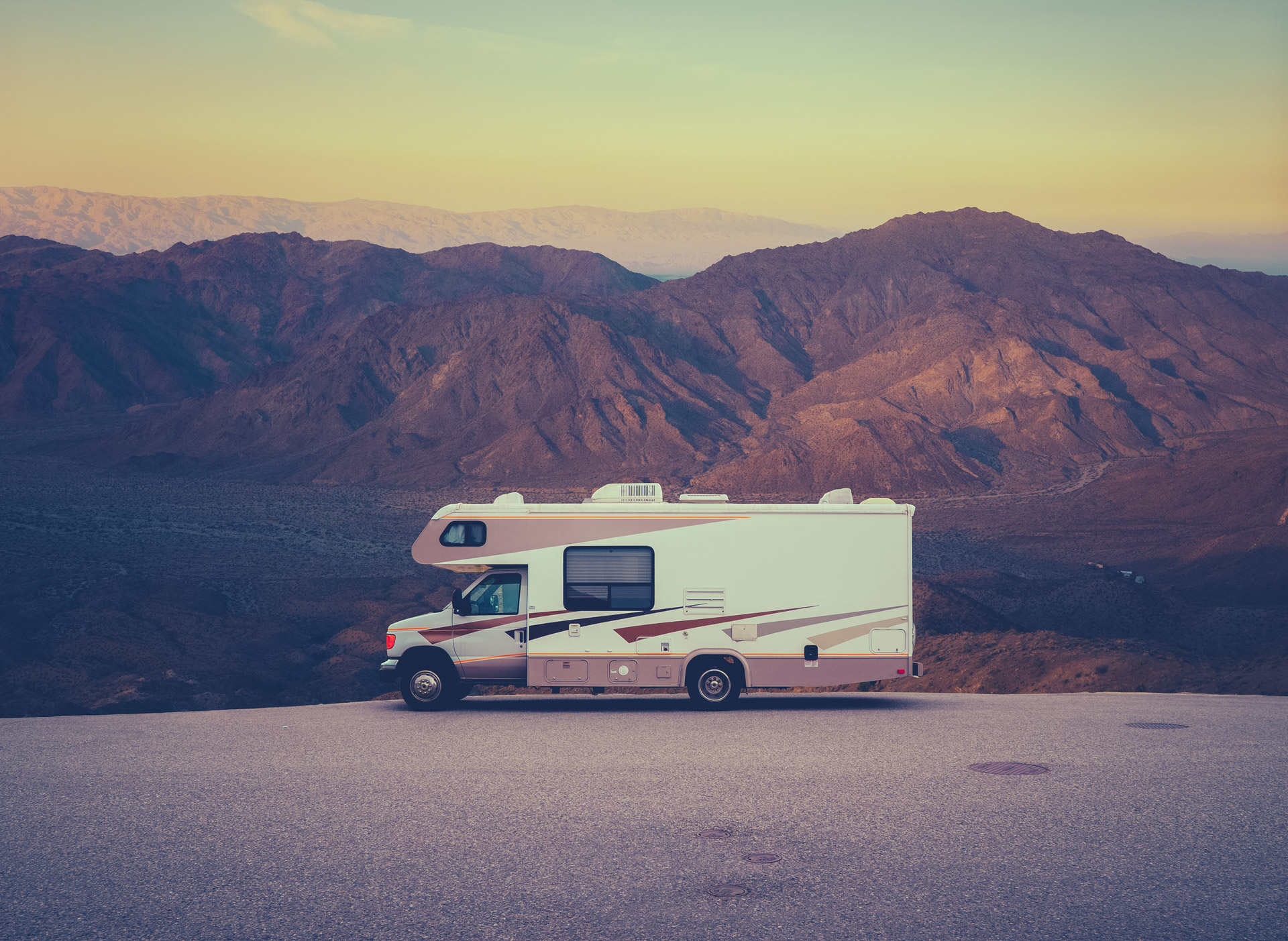 RV parked in front of mountains