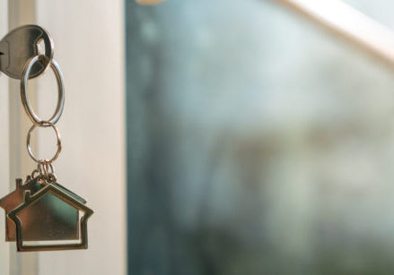 House doors with keys and house-shaped keychain